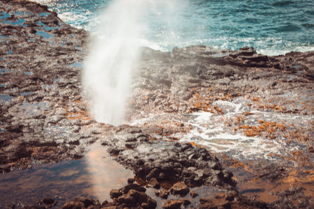Spouting Horn is off the southern coast of Kauai in the Koloa district and is known for its crashing waves and large sprays of water.の写真素材