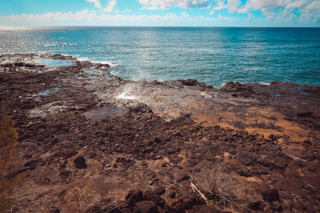 Spouting Horn is off the southern coast of Kauai in the Koloa district and is known for its crashing waves and large sprays of water.の写真素材