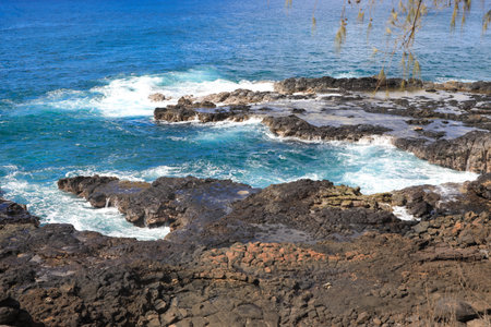 Spouting Horn is off the southern coast of Kauai in the Koloa district and is known for its crashing waves and large sprays of water.の写真素材