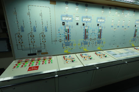 ship engine room dashboard with plenty of bottoms, indicators, small indication lamps and schematics of engines and generators, voltmeters, amperemetersの写真素材