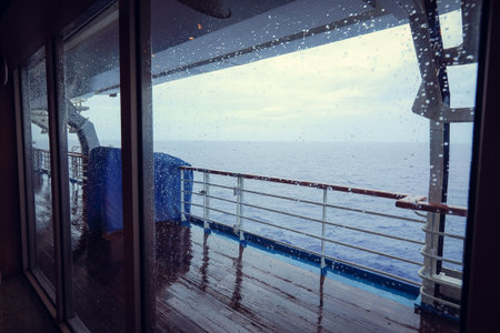 Cruise ship Open deck with Rescue Lifeboats and life buoy through the Window in raindrops
