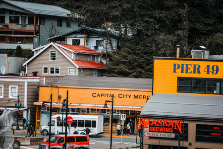 Juneau, Alaska - July 11, 2025: The historic waterfront at Pier 49 featuring the Alaskan Brewing Public House and the wooden boardwalk on a summer afternoon