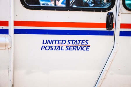 Juneau, Alaska - August 29, 2025:Close-up of the United States Postal Service logo and text on a white mail delivery truck.