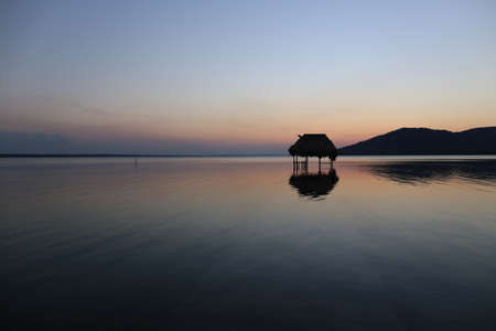 Overwater Hut and Sunset - Lake Peten Itza in Guatemalaの写真素材