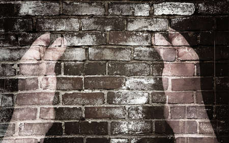 Left and right hand and the brick wallの写真素材