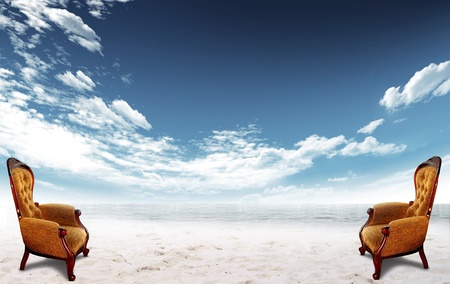 Chairs on the beach with sea and sky with clouds in the backgroundの写真素材