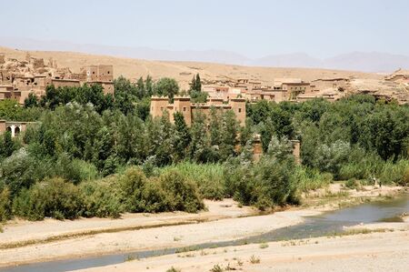 Morocco landscape: river valley, wadi, with traditional village in the background の写真素材