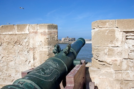 Essaouira, Morocco: cannon at the harbour fortification with Purpuraires island in the backgroundのeditorial素材