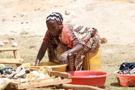 African woman in traditional clothes are washing the clothes in ethiopian rural area, Ethiopiaのeditorial素材