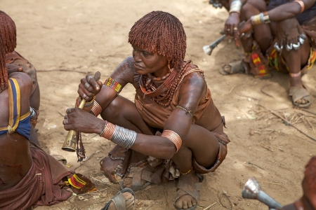 Turmi, Ethiopia, February 16, 2013: african woman of the Hamer ethnic group, is showing her tribal hairstyle and body paint at the jumping of the bull ceremonyのeditorial素材
