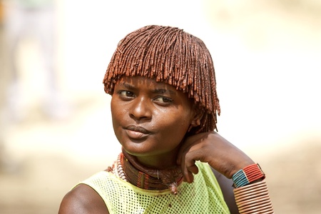 Turmi, Ethiopia, February 16, 2013: african woman of the Hamer ethnic group, is showing her tribal hairstyle and necklaces at the jumping of the bull ceremonyのeditorial素材