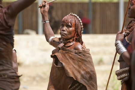 Turmi, Ethiopia, February 16, 2013: old african woman of the Hamer ethnic group, is showing her tribal hairstyle, necklace of the first wife and body paint at the jumping of the bull ceremonyのeditorial素材