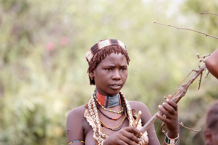 Turmi, Ethiopia, February 16, 2013: african woman of the Hamer ethnic group is showing the tribal hairstyle and necklaces at the jumping of the bull ceremony.のeditorial素材