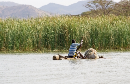 Arba Minch, Ethiopia, February 21, 2013: african fisherman with traditional boat is going to fish on the lake Chamo.のeditorial素材
