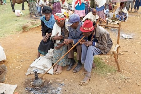 Dorze village, Ethiopia, February 21, 2013: old african people of the Dorze ethnic group are smoking the traditional pipe at the Dorze village market.のeditorial素材