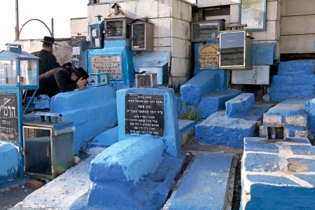Safed, Israel, June 17, 2013  orthodox jewish men are praying on the old graves at the old jewish cemeteryのeditorial素材