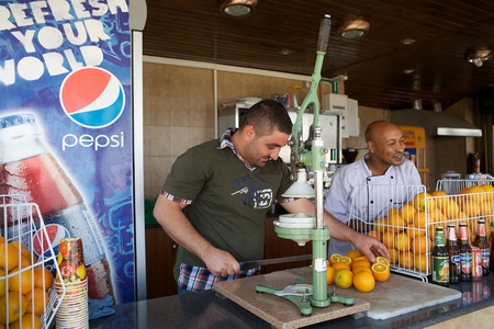 Jericho, Palestine, Israel, June 18, 2013  palestinian man is ready to make orange juice with fresh oranges at the bar on the Mount of the Temptationのeditorial素材