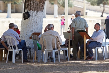 Muslim men are reading the holy book outside the mosque at the Temple Mount, Jerusalem, Israelのeditorial素材