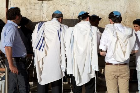 Jewish men are praying at the Western Wall at the Jerusalem old town, Jerusalem, Israel