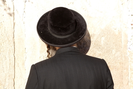 Jewish orthodox man are praying at the Western Wall in the Jerusalem old town, Jerusalem, Israel