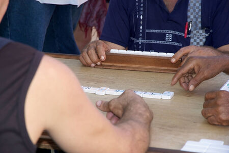 Cuban people are playing dominoes along the street at the Trinidad, Cuba