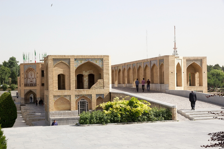 Iranian people are crossing the Khaju Bridge at Isfahan, Iran. Khaju Bridge was built by the persian Safavid King Shah Abbas II around 1650, serving as both a bridge and a dam across the Zayandeh river, now dry in town. Khaju Bridge has 24 arches and is 1のeditorial素材