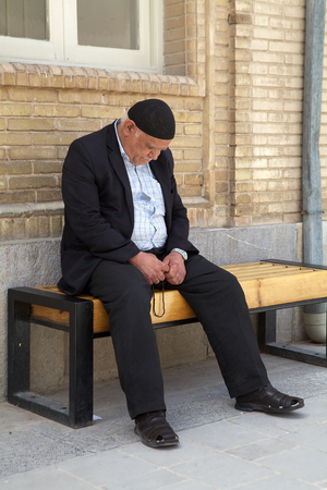 Old armenian man is praying outside the Vank Cathedral in the Jolfa quarter at Isfahan, Iran  Van Cathedral was one of the first churches  to be established in the armenian quarter of Isfahan  The costraction have begun in 1606 and completed between 1655 のeditorial素材