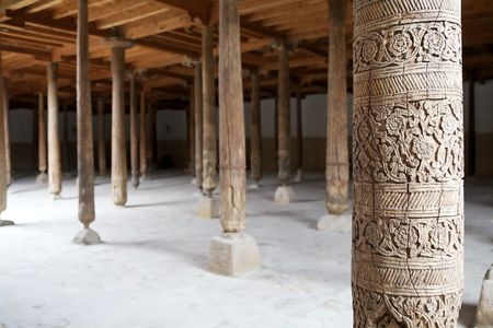 Finely carved wooden column at the Djuma Mosque at the Itchan Kala, Khiva, Uzbekistan. Itchan Kala is the walled inner town of the city of Khiva. Since 1990 it has been protected as a World Heritage Site. The interior space of the Djuma Mosque is a singleの写真素材