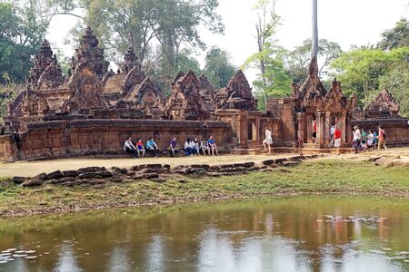 Tourists are visiting the Banteay Srei temple, located in the area of Angkor,Siem Reap, Cambodia. Banteay Srei temple is a 10th century temple dedicated to the Hindu God Shiva. It is built largely of red sandstone with elaborate decorative wall carving.のeditorial素材