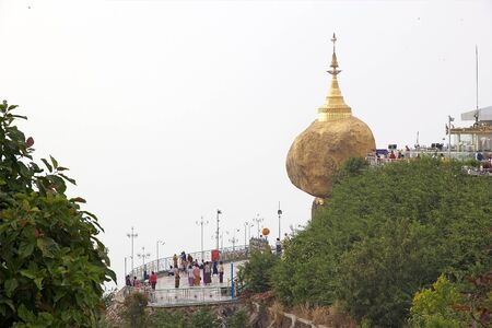 Kyaiktiyo Pagoda, Golden Rock, Kyaiktiyo, Myanmar or Burma. Kyaiktiyo Pagoda also known as Golden Rock is a well known Buddhist pilgrimage site in the Mon State, Myanmar. It is a small pagoda, 7,3 m, built on the top of a granite boulder covered with goldのeditorial素材