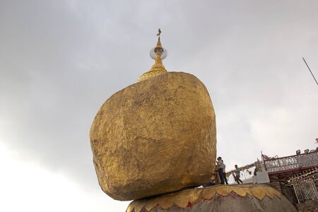 Pilgrims are praying at the Kyaiktiyo Pagoda, Golden Rock, Kyaiktiyo, Myanmar or Burma. Kyaiktiyo Pagoda also known as Golden Rock is a well known Buddhist pilgrimage site in the Mon State, Myanmar.のeditorial素材