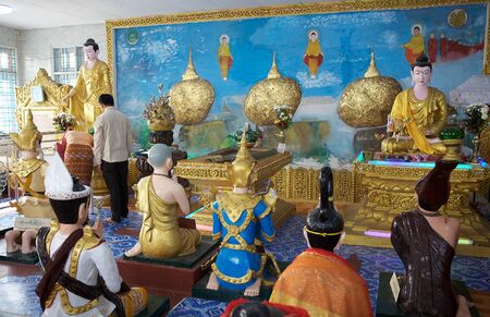 Oilgrims are praying in the temple near the Kyaiktiyo Pagoda