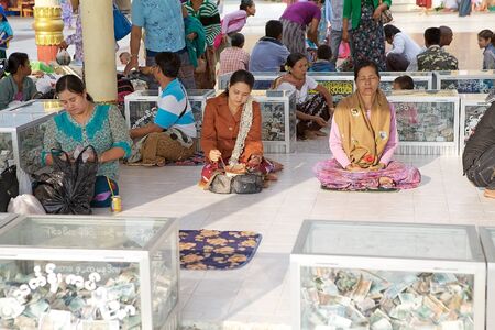 Pilgrims are praying at the Golden Rock Pagoda Kyaiktiyo Kyaiktiyo Myanmar or Burma. Kyaiktiyo Pagoda anche known as Golden Rock is a well known Buddhist pilgrimage site in the Mon State Myanmar.のeditorial素材