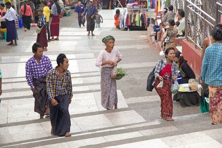 Pilgrims are walking along the street near the Golden Rock Pagoda Kyaiktiyo Kyaiktiyo Myanmar or Burma. Kyaiktiyo Pagoda anche known as Golden Rock is a well known Buddhist pilgrimage site in the Mon State Myanmar.のeditorial素材