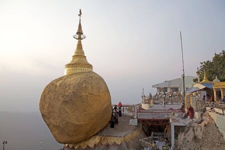 Pilgrims are praying and pasting gold leaves at the Kyaiktiyo Pagoda Golden Rock Kyaiktiyo Myanmar or Burma. Kyaiktiyo Pagoda also known as Golden Rock is a well known Buddhist pilgrimage site in the Mon State Myanmar. It is a small pagoda 73 m built on tのeditorial素材
