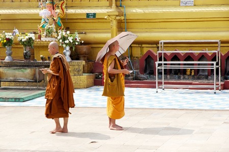 Bhuddist monks in traditional robes are visiting the Shwemawdaw Paya site Bago Myanmar. Shwemawdaw Paya is a stupa located in Bago Myanmar. It is often referred to as the Golden God Temple. At 114 m in height it is the tallest pagoda in Myanmar. The Shwemのeditorial素材
