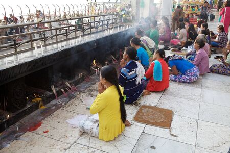 Pilgrims are praying at the Kyaiktiyo Pagoda Golden Rock Kyaiktiyo Myanmar or Burma. Kyaiktiyo Pagoda also known as Golden Rock is a well known Buddhist pilgrimage site in the Mon State Myanmar. It is a small pagoda 73 m built on the top of a granite boulのeditorial素材