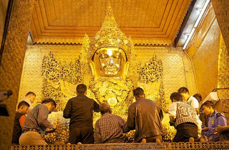 Pilgrims are praying at the Mahamuni Buddha Temple, Mandalay, Myanmar.のeditorial素材