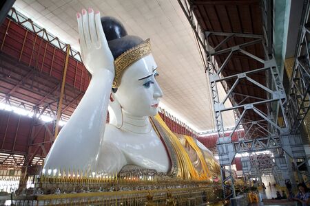 The giant reclining Buddha at the Chaukhtatgyi Buddha Temple, Yangon, Myanmar. The temple houses one of the most revered reclining Buddha in the Country. The Buddha image was 66 metres long and one of the largest in Myanmar. The construction began in 1899のeditorial素材
