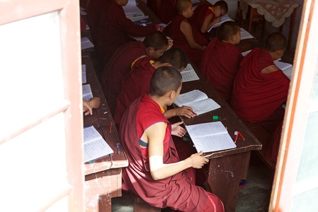 Buddhist monks in traditional robes are studying in the classroom at the Dali Monastery, Darjeeling, West Bengal, India. Dali Monastery is located in Dali, about 5 km from Darjeeling. Although known as the Dali Monastery, its name is Druk Sangag   Cholingのeditorial素材