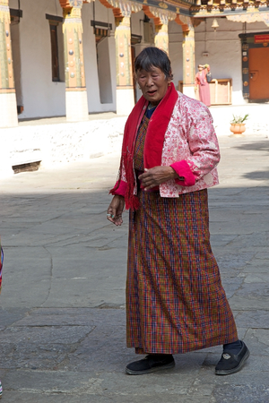 Bhutanese woman in traditional clothes is attending at the birth anniversary ceremony of the 4th King at the Punakha Dzong, Punakha, Bhutan. The Dzong was built in 1637-38 by Ngawang Namgyal, 1st Zabdrung Rimpoche. The Dzong is the second oldest and seconのeditorial素材