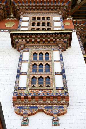 Architecture details, wooden frontage with small arche windows, of the Kurjey Lhakhang also known as Kurjey Monastery is located in the Bumthang Valley in the Bumthang District, Bhutan. This is the final resting place of the first three King of Bhutan. Alの写真素材