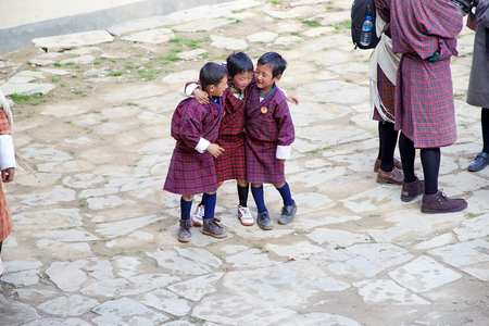 Bhutanese children in traditional clothes are attending at the ceremony during the Black-necked crane Festival at the Gangtey Monastery also known as Gantey Gompa, Gangten, Bhutan. Gangtey Monastery is an important monastery of Nyingmapa school of Buddhisのeditorial素材