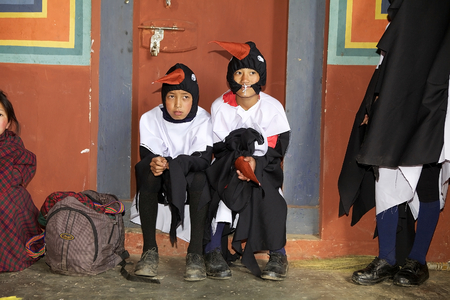 Black-necked crane young dancers in traditional mask in the backstage are waiting to perform their show during the Black-necked crane Festival at the Gangtey Monastery also known as Gantey Gompa, Gangten, Bhutan. Gangtey Monastery is an important monasterのeditorial素材