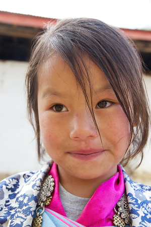 Bhutanese child in traditional clothes is attending at the ceremony during the Black-necked crane Festival at the Gangtey Monastery also known as Gantey Gompa, Gangten, Bhutan. Gangtey Monastery is an important monastery of Nyingmapa school of Buddhism. Tのeditorial素材