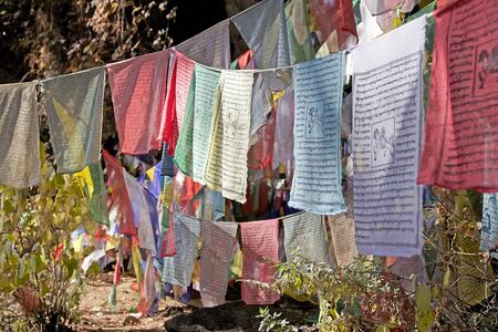 Prayer flags along the footpath to the Tiger's Nest, Paro, Bhutan. The flags do not carry prayers to...