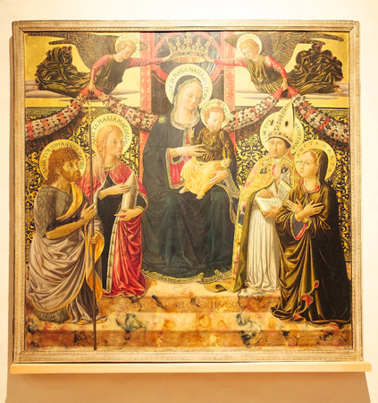 Madonna and Child, two angels and Saints John de Baptist, Mary Magdalene, Augustine and Martha painting, tempera on wood, 1466 by Benozzo Gozzoli, from the Monastery of Santa Maria Maddalena in San Gimignano, Tuscany, Italy.のeditorial素材