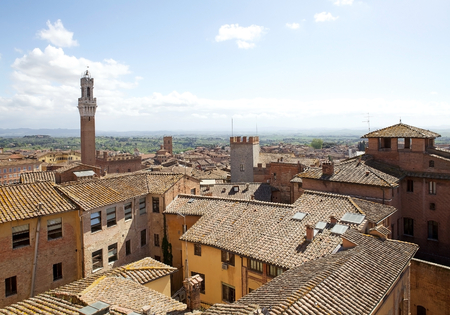 Aerial view of the Torre del Mangia and the historic city of Siena, Tuscany, Italy, with the hills in the background.のeditorial素材