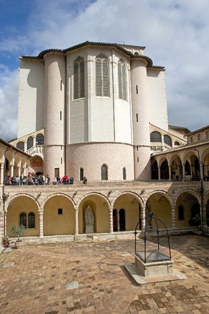 Pilgrims and tourists are visiting the Friary of St. Francis next to the Basilica of San Francesco d'Assisi in Assisi, Italy. It was built with pink and white stone from Mount Subasio. Next to cathedral stands the Friary of St. Francis with its imposing wのeditorial素材