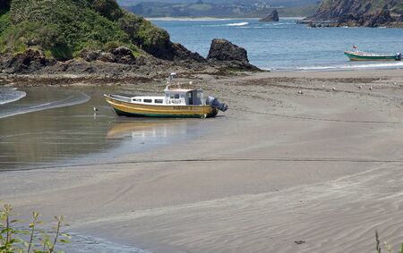 View of Punihuil beach in the northwestern cost of Greater Island of Chiloe, Chile. Punihuil is a cove with a small community. Three small island lie to the west and north of the cove and they are a breeding site for Humboldt and Magellanic penguinsのeditorial素材